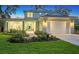 Two-story home with a white exterior, landscaping, and a two-car garage at 2492 S Milmar Dr, Sarasota, FL 34237