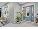 Light blue front door with glass panels and plants at 2492 S Milmar Dr, Sarasota, FL 34237
