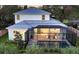Two-story house with metal roof and screened pool at 2492 S Milmar Dr, Sarasota, FL 34237