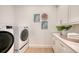 Convenient laundry room with washer, dryer, and cabinets at 2492 S Milmar Dr, Sarasota, FL 34237