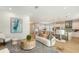 Open living room and kitchen with light-colored furniture and decor at 2492 S Milmar Dr, Sarasota, FL 34237