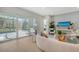 Living room with sliding glass doors to a pool and outdoor kitchen at 2492 S Milmar Dr, Sarasota, FL 34237