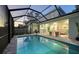 Enclosed pool and patio area with outdoor kitchen at 2492 S Milmar Dr, Sarasota, FL 34237