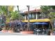 Outdoor dining area with tables, chairs, and umbrellas at 100 Sands Point Rd # 223, Longboat Key, FL 34228