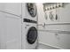 Laundry room with stacked washer and dryer at 100 Sands Point Rd # 223, Longboat Key, FL 34228