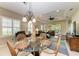 Casual dining area with glass-top table and wicker chairs at 11435 Fort Lauderdale Pl, Venice, FL 34293