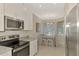 Modern kitchen featuring stainless steel appliances and granite countertops at 12413 Osorio Ct # 101, Sarasota, FL 34238