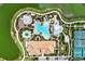 Aerial view of community pool, tennis courts, and clubhouse at 12413 Osorio Ct # 101, Sarasota, FL 34238