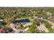 Aerial view of a home near a pond, surrounded by lush trees and greenery at 132 Shady Pkwy, Sarasota, FL 34232