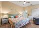 Spacious bedroom with a sitting area and a bright coastal themed bedspread at 132 Shady Pkwy, Sarasota, FL 34232