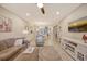 Bright and spacious living room with comfy seating and large TV at 13604 Messina Loop # 103, Lakewood Ranch, FL 34211