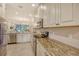 Modern kitchen with granite countertops, stainless steel appliances, and white cabinets at 13604 Messina Loop # 103, Lakewood Ranch, FL 34211