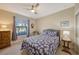 Cozy bedroom with a queen-size bed, armchair and window at 13604 Messina Loop # 103, Lakewood Ranch, FL 34211