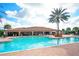 Resort-style pool with spacious deck and palm trees at 13604 Messina Loop # 103, Lakewood Ranch, FL 34211