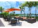 Relaxing community patio with seating, umbrellas, and scenic views at 13604 Messina Loop # 103, Lakewood Ranch, FL 34211