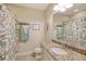 Well-appointed bathroom with granite countertop, shower, and decorative shower curtain at 13604 Messina Loop # 103, Lakewood Ranch, FL 34211