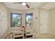 Bright dining area with a wood table and white chairs near the entryway at 13604 Messina Loop # 103, Lakewood Ranch, FL 34211