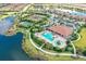 Aerial view of community with pool, tennis courts, and clubhouse at 13604 Messina Loop # 103, Lakewood Ranch, FL 34211