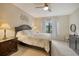 Spacious bedroom with a queen bed, nightstand and window with natural light at 13604 Messina Loop # 103, Lakewood Ranch, FL 34211