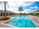 Relaxing pool area with lounge chairs and landscaping at 13604 Messina Loop # 103, Lakewood Ranch, FL 34211