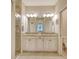 Elegant bathroom with double vanity, granite countertop and large mirror at 13604 Messina Loop # 103, Lakewood Ranch, FL 34211