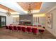 Community dining room with a long table, fireplace, and wine storage at 13604 Messina Loop # 103, Lakewood Ranch, FL 34211