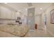 Modern kitchen with granite countertops, stainless steel appliances, and white cabinets at 13604 Messina Loop # 103, Lakewood Ranch, FL 34211
