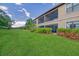 Spacious backyard with lush green lawn and beautiful landscaping at 13604 Messina Loop # 103, Lakewood Ranch, FL 34211