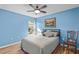 Bedroom with a queen bed, ceiling fan, and light blue walls at 214 Patterson Ave, Osprey, FL 34229