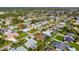 An aerial view showcasing a house with a pool in a neighborhood setting at 23095 Langdon Ave, Port Charlotte, FL 33954