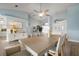 Bright dining room with hardwood floors, a large table, and access to a screened patio at 23095 Langdon Ave, Port Charlotte, FL 33954