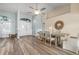 Bright dining room with hardwood floors, a large table, and access to a screened patio at 23095 Langdon Ave, Port Charlotte, FL 33954