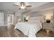 Spacious bedroom with large bed, wood floors, and ceiling fan at 23095 Langdon Ave, Port Charlotte, FL 33954