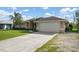 Spacious driveway and house exterior with a large garage at 23095 Langdon Ave, Port Charlotte, FL 33954