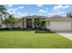 Beautiful two-car garage and well-maintained landscaping at 23095 Langdon Ave, Port Charlotte, FL 33954