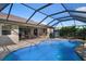 Inviting pool area with screened enclosure and patio furniture at 23095 Langdon Ave, Port Charlotte, FL 33954