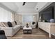 Modern living room featuring a sectional sofa and large flat screen TV at 23095 Langdon Ave, Port Charlotte, FL 33954