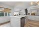 Modern kitchen featuring a large island, stainless steel sink, and white cabinets at 23095 Langdon Ave, Port Charlotte, FL 33954