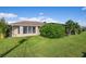 Well-maintained house exterior with manicured lawn and tropical landscaping at 23095 Langdon Ave, Port Charlotte, FL 33954