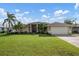 Beautiful house exterior with lush lawn at 23095 Langdon Ave, Port Charlotte, FL 33954