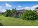 Landscaped backyard with lush greenery and a view of the pool at 23095 Langdon Ave, Port Charlotte, FL 33954