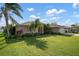 Charming single-story home with a well-maintained lawn and landscaping at 23095 Langdon Ave, Port Charlotte, FL 33954