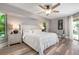Spacious main bedroom with a king-size bed, nightstands and large windows at 23095 Langdon Ave, Port Charlotte, FL 33954