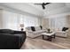 Spacious living room with sectional sofa and large windows at 23095 Langdon Ave, Port Charlotte, FL 33954