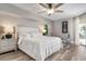 Spacious main bedroom with a king-size bed, nightstands and large windows at 23095 Langdon Ave, Port Charlotte, FL 33954