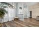 Light and airy entryway with hardwood floors and a view to the dining room at 23095 Langdon Ave, Port Charlotte, FL 33954