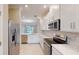 Modern kitchen with stainless steel appliances and white cabinets at 23887 Collina Way # 5203, Port Charlotte, FL 33980