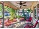 Relaxing screened porch with red chairs and plants at 2710 51St W Ave, Bradenton, FL 34207