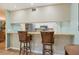 Kitchen breakfast bar with two chairs, looking into kitchen at 2710 51St W Ave, Bradenton, FL 34207