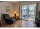Living room with tiled floors, sliding glass doors to a balcony, and relaxing furniture at 3935 Lake Bayshore Dr # F-316, Bradenton, FL 34205
